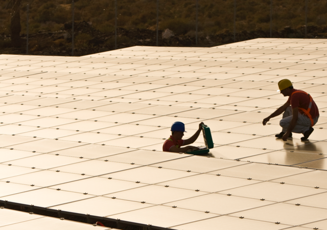 Workers installing solar panels