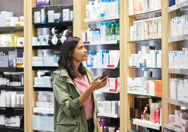 Woman shopping shelves of products.