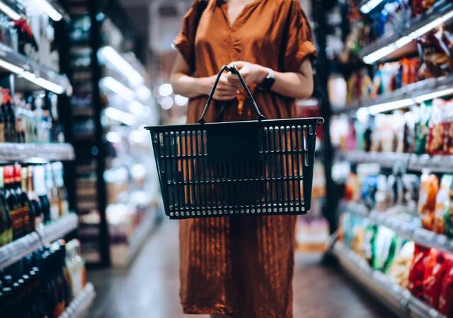 Woman carrying a shopping basket