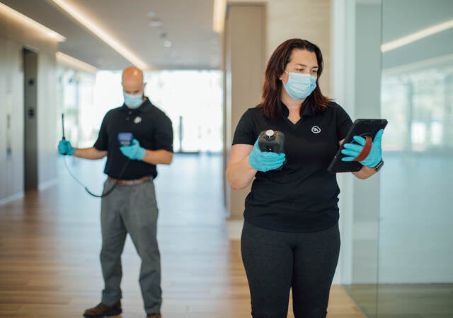 Two UL insprectors in masks conducting indoor air quality testing