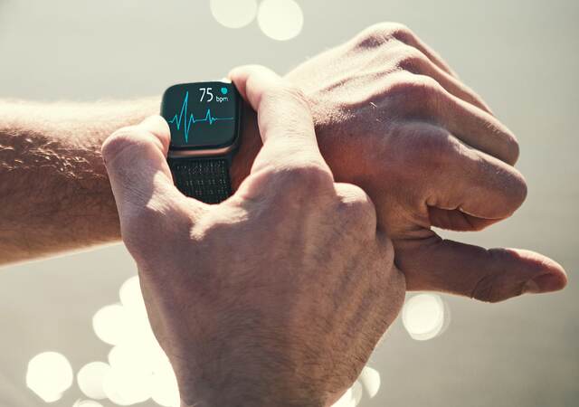 Man checking heart rate on a smart watch