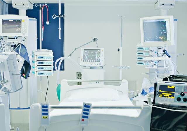 Empty hospital bed in intensive care