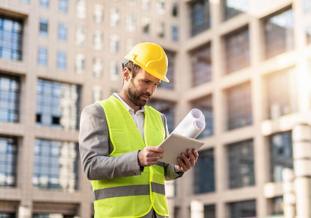 Serious engineer using digital tablet