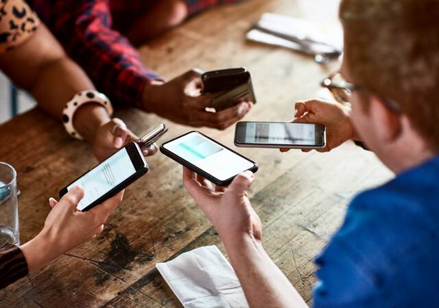 Friends sharing information on smartphones