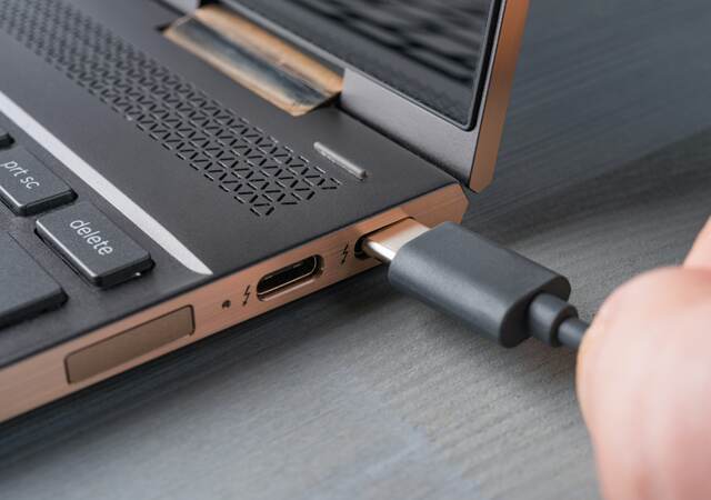 USB Type-C® grey cable being connected to a laptop.