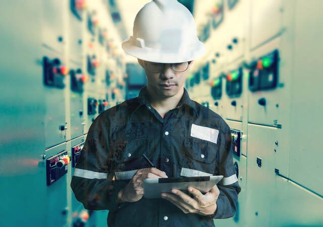 Double exposure of Engineer or Technician man working with tablet in switch gear electrical room of oil and gas platform or plant industrial for monitor process, business and industry concept.