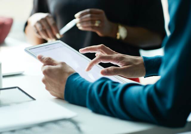 Person holding a tablet meeting with a customer