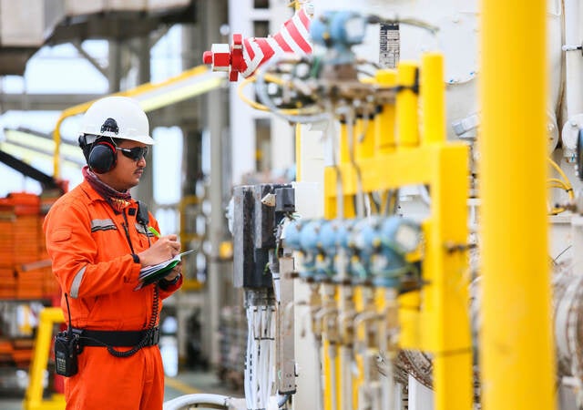 Worker checking gas pipes