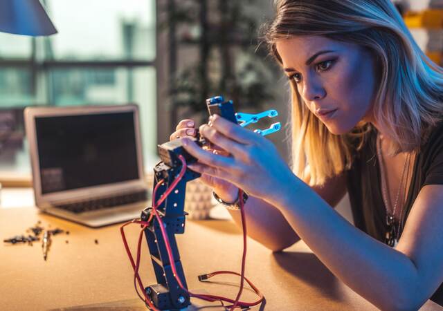 Person working in a robotics workshop