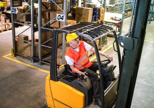 Worker driving a forklift