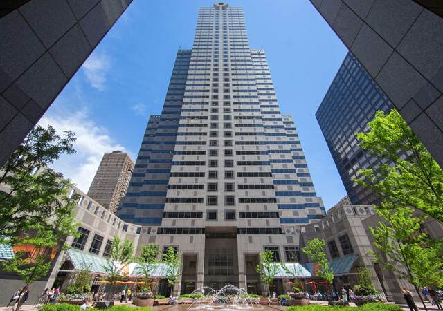 Viewing a tall office building surrounded by blue sky