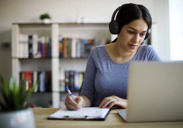 Woman in headset taking an e-learning course