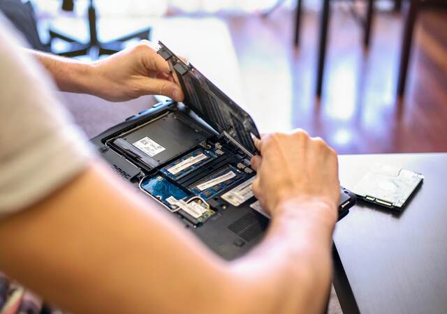 Laptop being opened to check battery