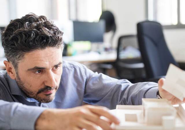 Architect adjusting a building model