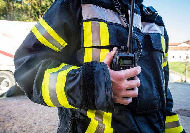 Firefighter using a walkie-talkie during a rescue operation