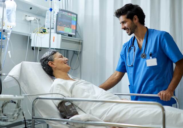 A nurse is attending to a patient.