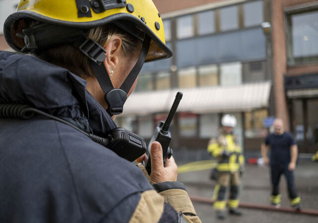 Firefighter with radio communication device