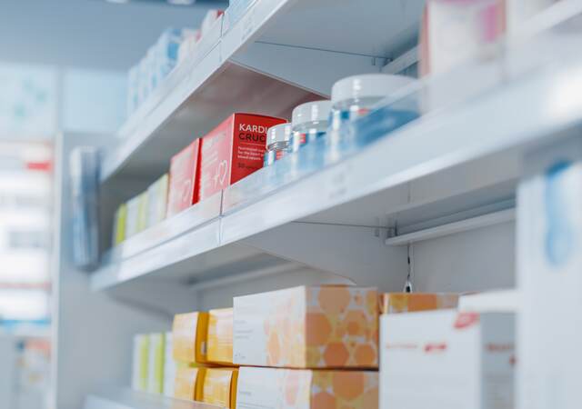 Pharmacy shelf with health and wellness products.