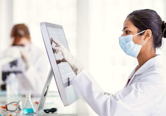 Scientist reviewing results on a computer