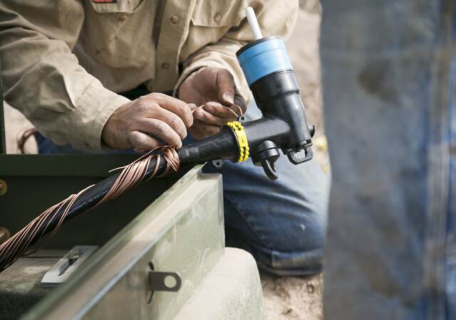 Worker installing medium voltage cable.