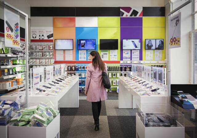 Woman browses products in an electronics store.