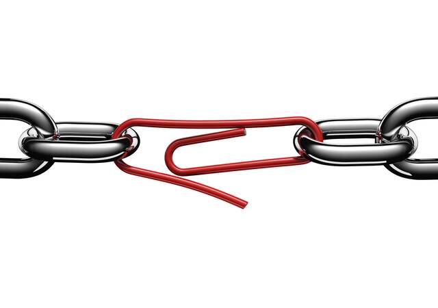 Steel chain links connected by a strained red paper clip.