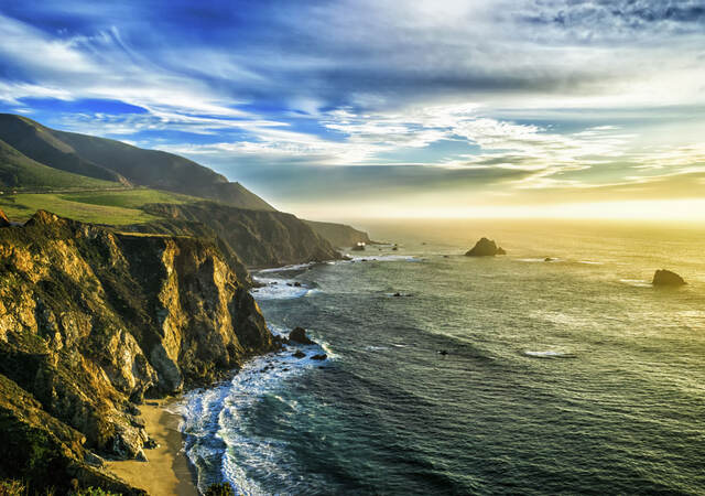 The coastline at Big Sur, California, with steep cliffs and rock stacks in the Pacific Ocean