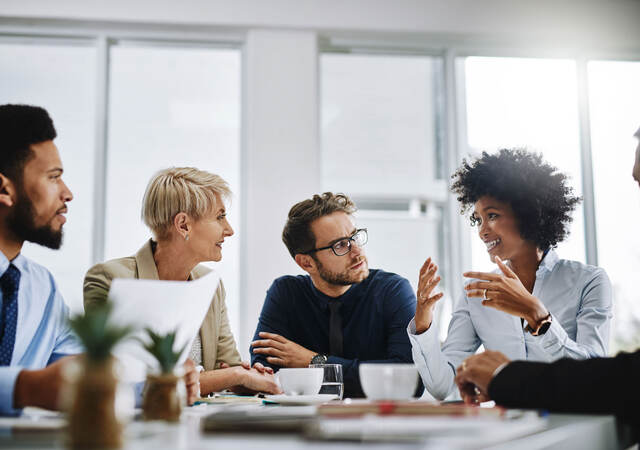 A group of businesspeople sitting together in a meeting.