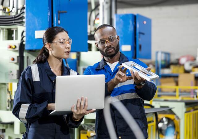 Two people looking over a device.