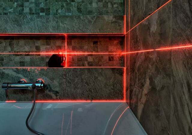 Laser measurement during bathroom renovation.