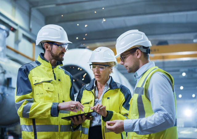 Three engineers discussing a project