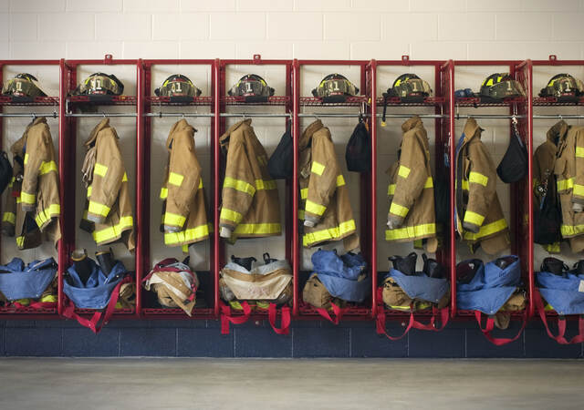 Firefighter suits hung in a row