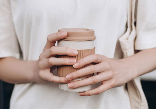 A person holding a coffee mug