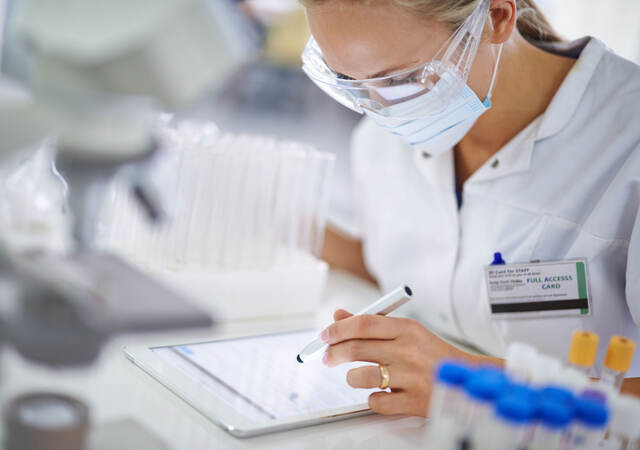 Doctor browsing the document on a tablet for information