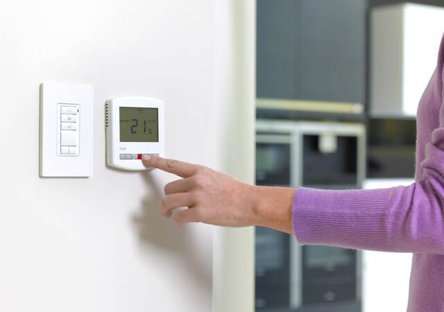 Woman changing heating.