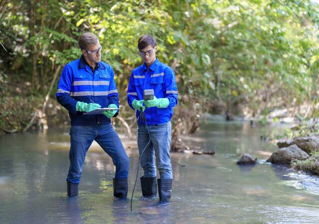 Environmentalists taking water samples in a creek