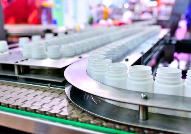 White plastic bottles on a production line