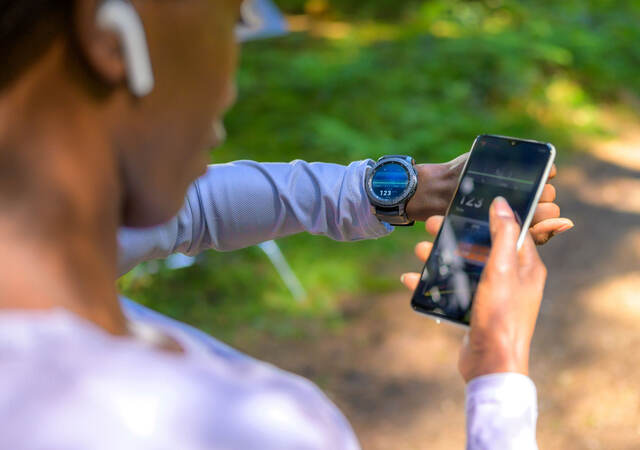 A person using tracker software and a smart watch