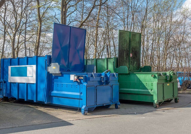 Two large garbage compactors.