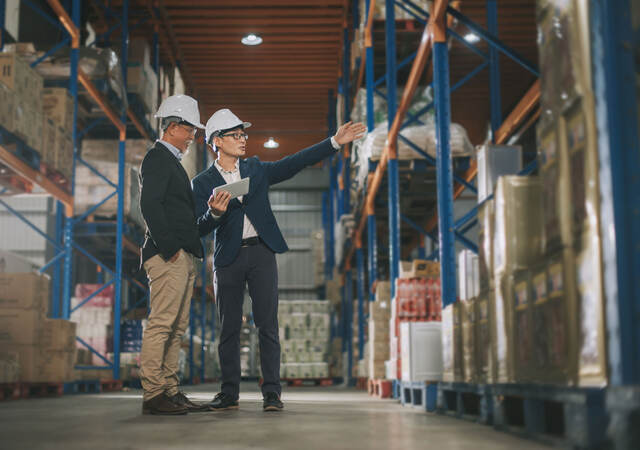 Two managers touring a warehouse