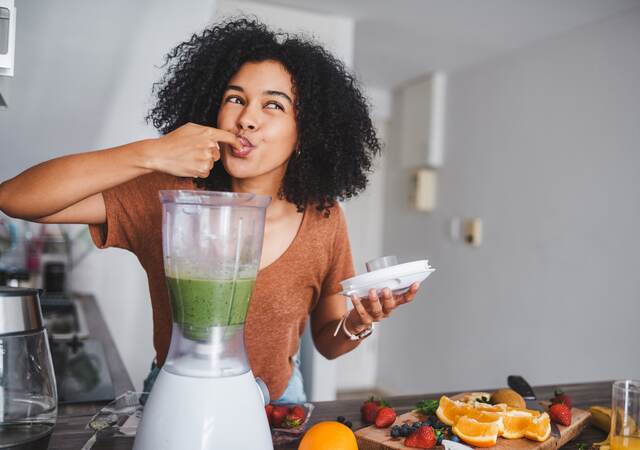 Woman with kitchen appliance.