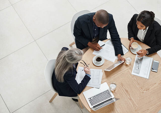 Overhead view of three business professionals having a meeting