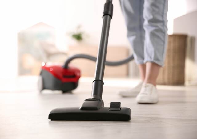 Woman with vacuum cleaner.