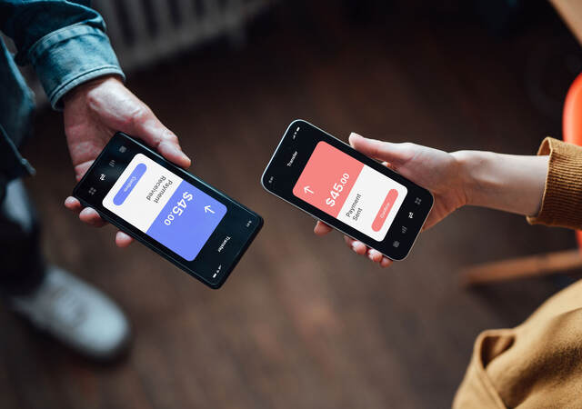 Closeup of two people managing online banking with smart phone