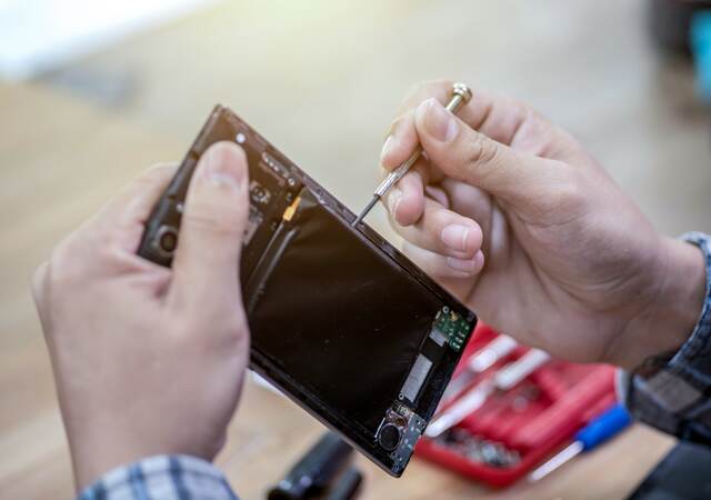 Man repairing a mobile phone.