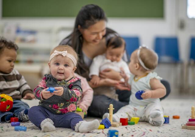 Childcare worker with babies.