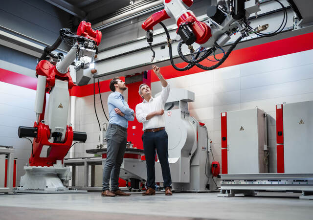 An engineer explaining a robotic arm