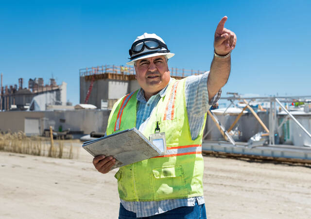 A construction worker pointing