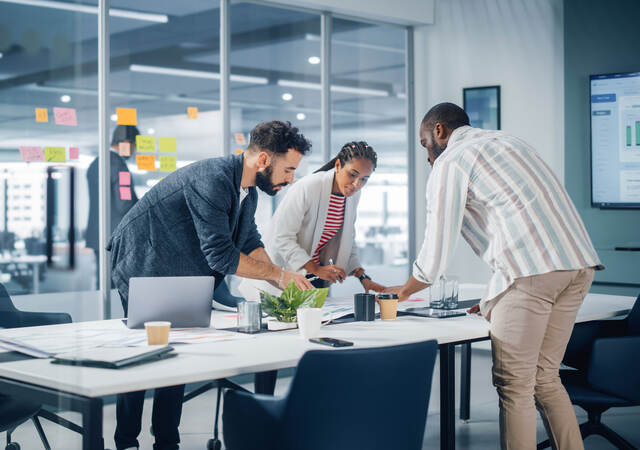 A diverse team collaborates over a conference table