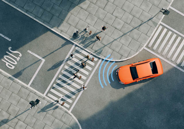 Ariel view of an orange car on a street